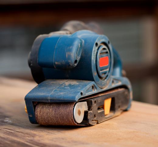 Belt sanders smooth wooden surfaces by spinning a roll of sandpaper in a continuous loop.