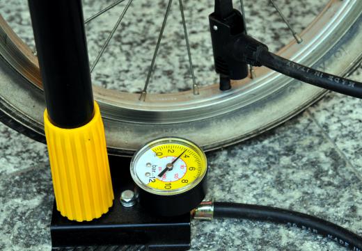 A bicycle hand pump with an air pressure gauge.