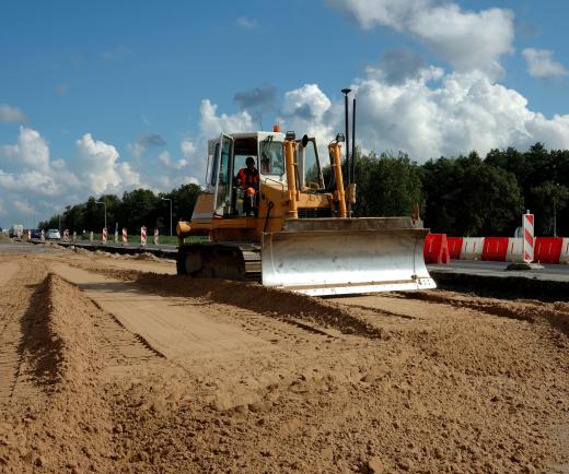 A bulldozer is a large tracked vehicle with a movable blade mounted on the front that pushes dirt and rocks around.