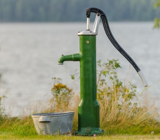 A hand water pump uses the power of suction to deliver water from an underground well.