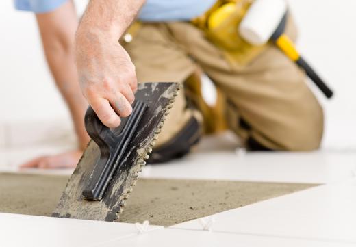 A handyman will use cement to bind the tile to the floor.