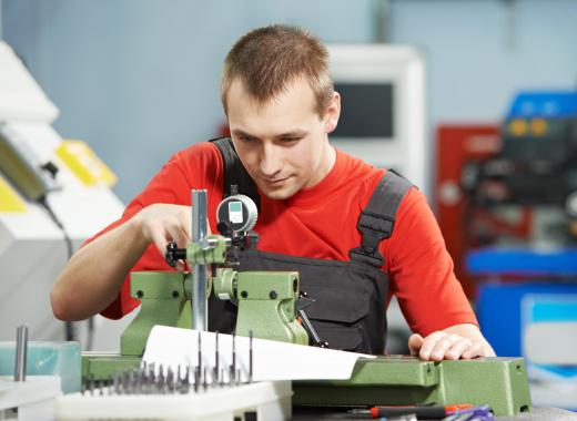 Workers in a manufacturing plant commonly wear coveralls designed to protect their body from metal shavings and other debris.