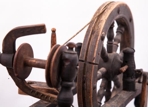 A spinning wheel is one of the tools required to process raw cotton into finished cotton.