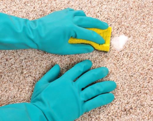 A person wearing protective gloves while cleaning.