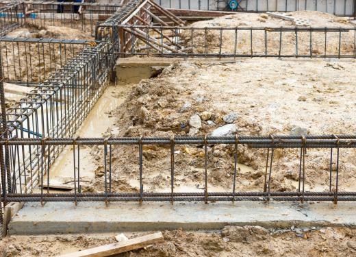 Metal reinforcing bars, or rebar, are inserted into concrete to provide stability.