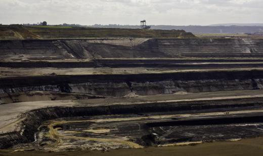 Rock and dirt are removed in layers during strip mining.