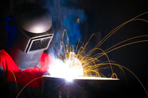 A welding mask protects a shielding gas welder's eyes and face.